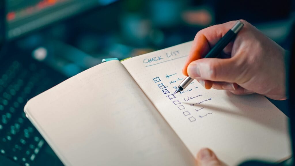 Freelancer working at a desk reviewing receipts and laptop