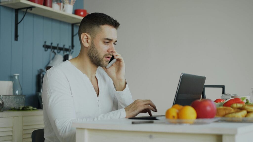 Freelancer at a laptop comparing QuickBooks Self-Employed alternatives